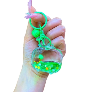 Cute green turtle acrylic liquid sand keychain with a mini TV design and metal bell