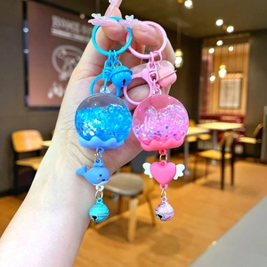 Porte-clés bouteille carillon à sable mouvant lumineux en rose et bleu pastel
