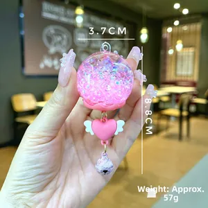 Pink heart keychain with quicksand sphere and bell, measuring 3.7cm wide and 8.8cm high