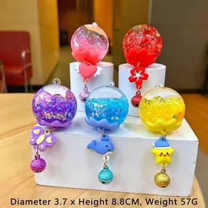 Glow wind chime keychain with colorful quicksand bottle and bells in multi-color set