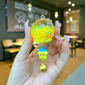 Close-up of a star-themed keychain with laser sequins and a cute yellow star figure