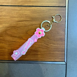 Pink Sakura cherry blossom silicone wristlet strap with gold keychain and lobster clasp