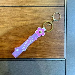 Detail of pink Sakura silicone wristlet strap with golden metal keychain and clasp