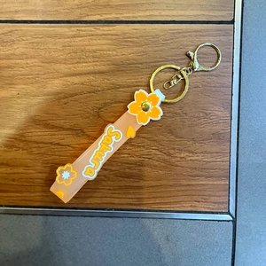 Detail of translucent peach Sakura silicone lanyard with golden metal ring and lobster clasp