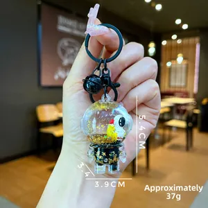 Close-up of liquid quicksand astronaut keychain with floating glitter and yellow duck