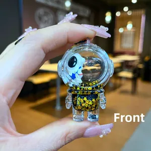 Front view of creative floating astronaut keychain with yellow star sequins in liquid