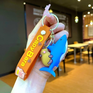 Cute Capybara and blue shark backpack keychain with orange wristlet strap and lucky charm