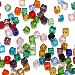 Macro detail of 8mm faceted crystal glass cube beads in assorted vibrant colors for DIY jewelry