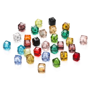 Macro view of 8mm faceted crystal cube beads in various vibrant colors for DIY jewelry