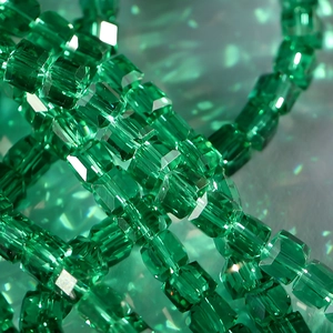Macro detail of 8mm faceted green crystal cube beads for DIY jewelry making and crafts