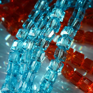 Macro shot of 8mm faceted blue and orange crystal cube beads for jewelry making