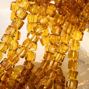 Macro shot of 8mm amber faceted crystal cube beads for DIY jewelry making and accessories