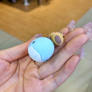 Detail of Capybara cartoon keychain featuring blue animal and bear pendant accessories
