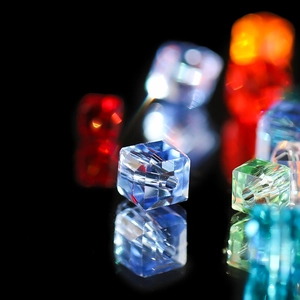 Macro shot of 8mm multi-faceted crystal glass cube beads with polished finish for DIY jewelry