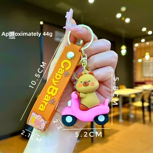 Detail view of cute cartoon Capybara keychain on pink scooter with size measurements