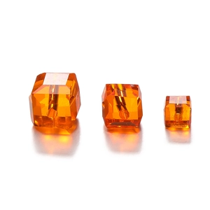 Macro shot of amber multifaceted crystal square beads in three sizes for DIY jewelry making