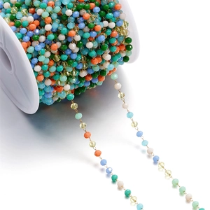 Macro shot of 3mm colorful faceted glass bead chains on a spool for DIY jewelry making