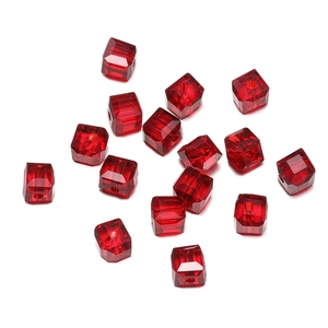 Detailed close-up of 8mm faceted red crystal cube beads with central holes for DIY jewelry
