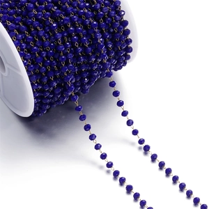 Detail of 3mm dark blue faceted crystal bead chain on a white spool for DIY jewelry