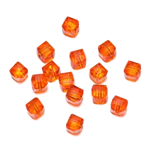 Macro shot of 8mm orange faceted crystal cube beads with precision drilled holes