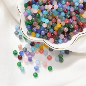 Détails de perles colorées en verre dans un plat en coquillage pour bijoux DIY