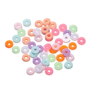 Macro view of colorful flat donut beads in various macaron colors for DIY jewelry making