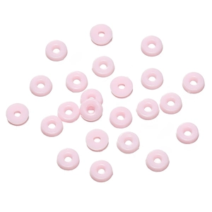 Flat lay of pink circular resin spacer beads for DIY jewelry and necklaces on white background