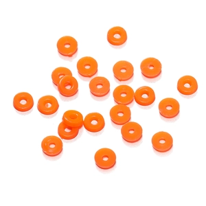 Close-up of orange flat round polymer clay beads for DIY jewelry making and crafts