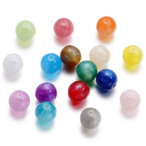 Dettaglio di perle colorate in resina da 8-12mm con glitter per creazione gioielli fai-da-te