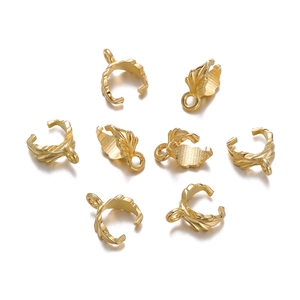 Macro detail of golden alloy leaf charms with intricate vein patterns and pinch bails