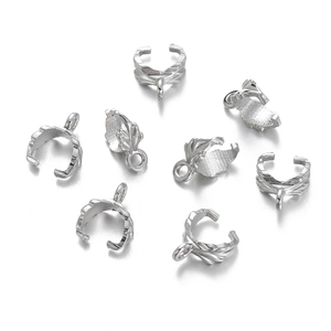 Detailed view of silver leaf-textured bail connectors for jewelry making and pendants