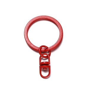 Detailed macro view of vibrant red paint coated keychain with swiveling lobster clasp