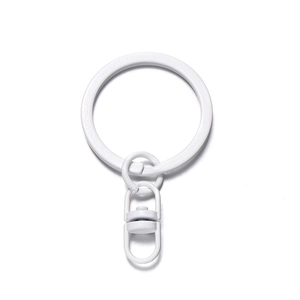 Detail of a white lacquered metal key ring and swivel clasp for DIY craft accessories