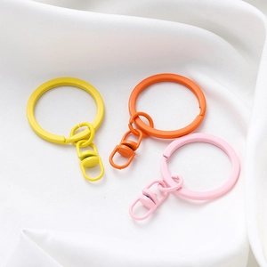 Close-up of matte colorful painted metal keyrings with rotating hooks for DIY crafts