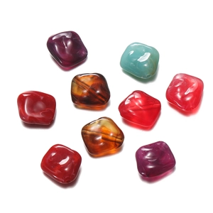 Macro detail of irregular acrylic beads with holes for DIY phone chain and jewelry crafting