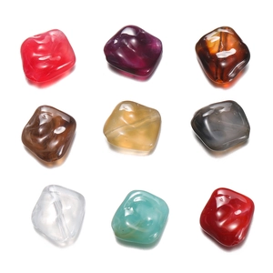 Close-up of colorful irregular acrylic stones with marble texture for DIY jewelry crafts