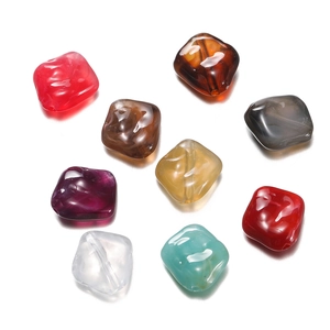 Macro shot of colorful irregular acrylic beads for DIY jewelry making with smooth finish