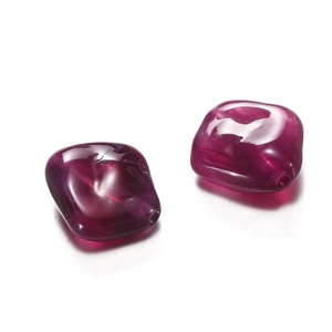 Macro view of translucent dark purple acrylic irregular beads with pre-drilled holes