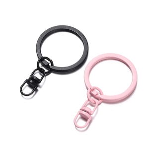 Detail of matte black and pink metal swivel keychain clips with lobster clasp and flat ring