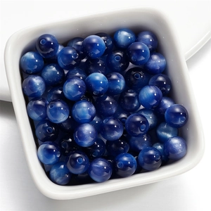 Macro view of deep blue resin cat eye beads for DIY necklace and jewelry making