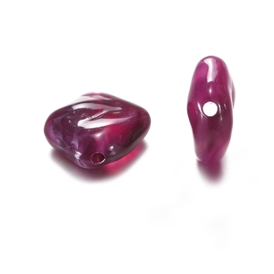 Macro detail of irregular purple acrylic beads with white marble texture and center hole