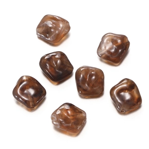 Macro view of coffee-colored marble pattern irregular acrylic beads for DIY jewelry