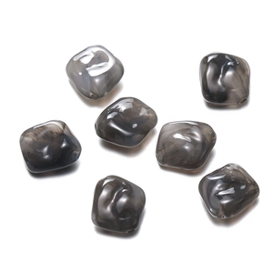 Macro shot of irregular grey marble acrylic beads with smooth edges for DIY jewelry