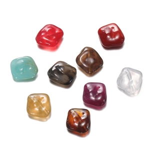 Close-up of assorted acrylic irregular stone beads with marble texture for DIY jewelry