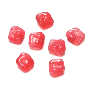 Macro shot of 7 red marble texture acrylic irregular beads for DIY jewelry making