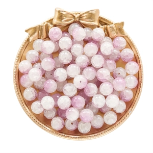 Macro detail of 10mm frosted ice cracked light purple glass beads in a gold tray