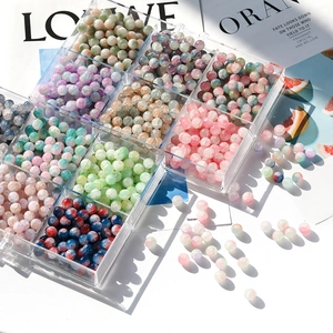 Detailed view of 10mm frosted ice-cracked glass beads in a nine-grid storage box
