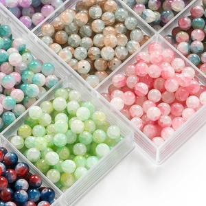 Close-up of 10mm frosted ice crack glass beads in a mesh organizer for DIY jewelry