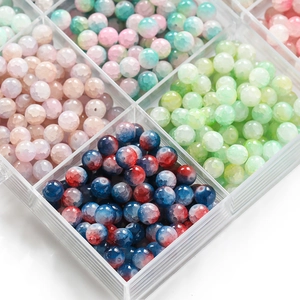 Macro shot of 10mm frosted ice-crack glass beads in a compartmentalized storage box