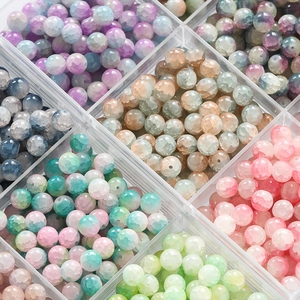 Macro shot of 10mm frosted ice crack glass beads in a sorted storage organizer